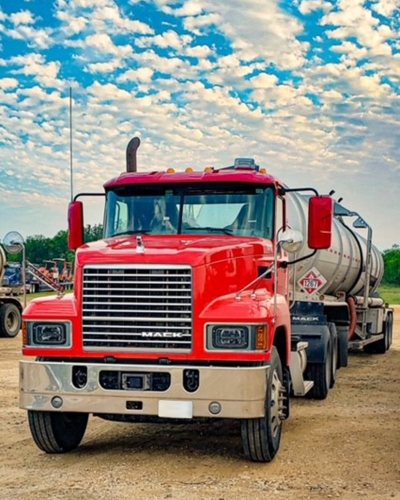 Image of an Equipment Transport fuel truck. Equipment Transport is a leading provider of midstream logistics solutions.